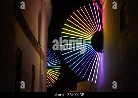 Colorful lightening stripes hanging on the wall of the building Stock Photo