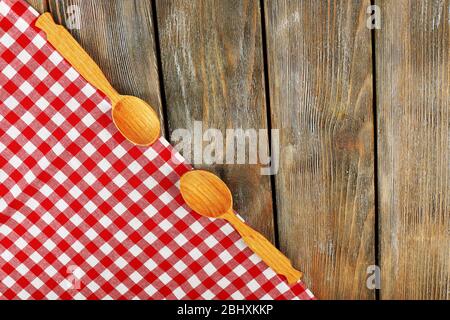 Checkered napkin with spoons on wooden table background Stock Photo