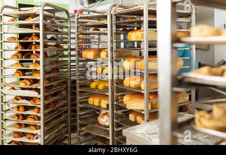 Freshly baked bread on racks in a bakery Stock Photo