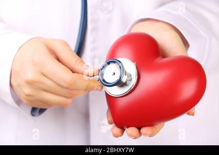 Doctor hands with stethoscope and red heart, closeup Stock Photo