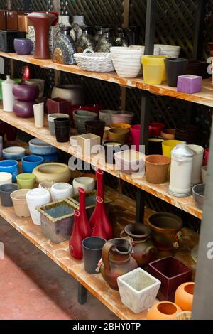 Variety of clay and plastic flowerpots and cachepots for houseplants on sale in store Stock Photo