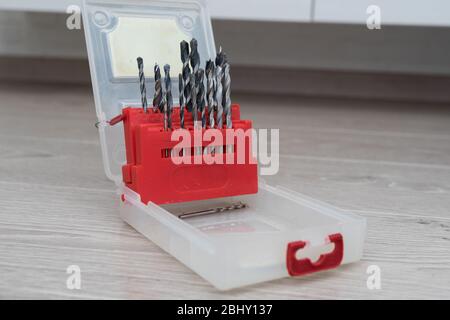 set of drill bits for drill in red box on wooden background Stock Photo