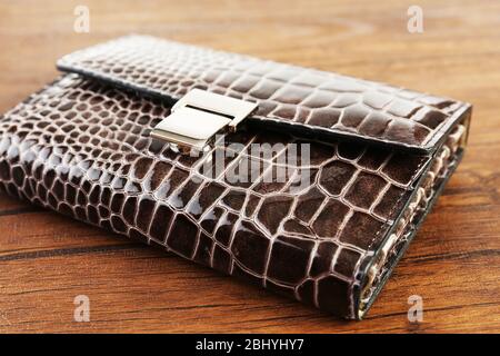Manicure set in closed leather case on wooden background Stock Photo