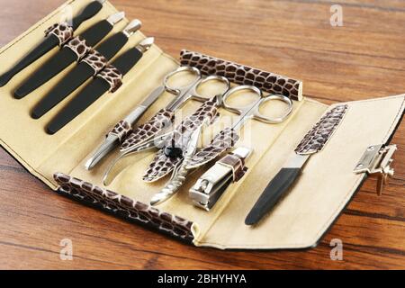 Manicure set in open case on wooden table, closeup Stock Photo