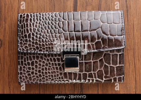 Manicure set in closed leather case on wooden background Stock Photo