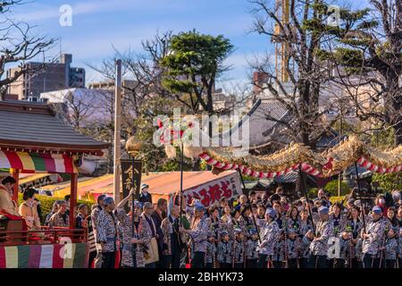 tokyo, japan - march 18 2020: Yatai cart overlooked in which sit the Matsuri-bayashi music musicians and the puppet masters holding the golden dragon Stock Photo