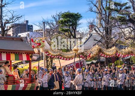 tokyo, japan - march 18 2020: Yatai cart overlooked in which sit the Matsuri-bayashi music musicians and the puppet masters holding the golden dragon Stock Photo