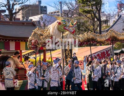 tokyo, japan - march 18 2020: Yatai cart overlooked in which sit the Matsuri-bayashi music musicians and the puppet masters holding the golden dragon Stock Photo