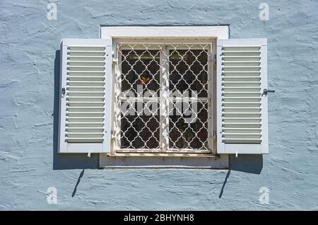 Barred window with shutters in the Old Town of Lindau in Lake Constance, Bavaria, Germany. Stock Photo
