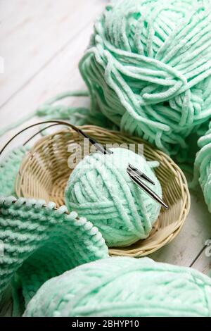 Knitting project in progress.piece of knitting with ball of yarn and a knitting needles. Stock Photo
