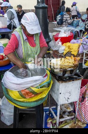 Street vendor selling produce at San Pedro Market  in Cusco, Peru Stock Photo