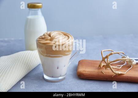 Dalgona coffee on a gray background. Fashionable drink with fluffy creamy based on milk, coffee and sugar. Copy space. Stock Photo