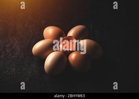 Raw chicken eggs on dark background, close up Stock Photo