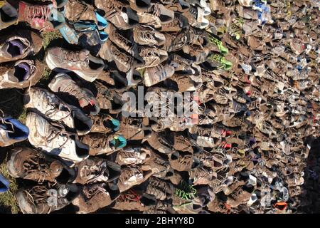 Rows of trainers after race muddy and old Stock Photo