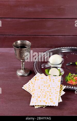 Matzo for Passover with Seder meal with wine on plate on table close up ...