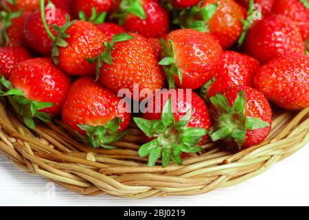 Ripe strawberries in wicker tray, closeup Stock Photo