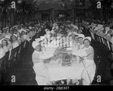 Pulling crackers at the Southern Hospital nurses Christmas dinner . - 1935 Stock Photo