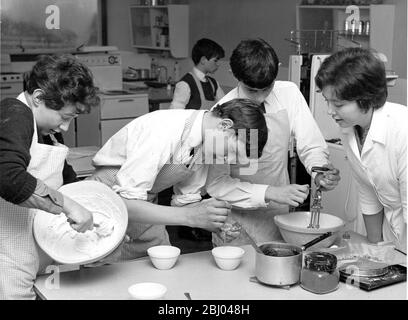 Cooking in the Classroom under the eye of their teacher Miss Moira Wright with David Mills, Martin Wilson and David Warner who are preparing chocolate meringues Westgate County Secondary School 8 February 1966 Stock Photo