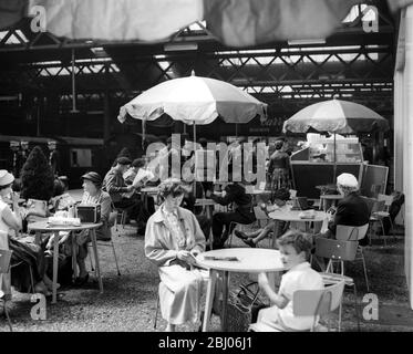 General view of travellers enjoying refreshment at Euston Station, London 1957