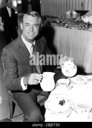 American film actor Cary Grant pours himself a cup of tea at the Savoy Hotel this afternoon , when he held a press reception . Cary Grant flew into London on Friday evening to attend the Premier of his latest film , ' North by Northwest ' , at the Empire Theatre , Leicester Square . He co - stars with Eva marie Saint and James Mason . - 11th October 1959 Stock Photo