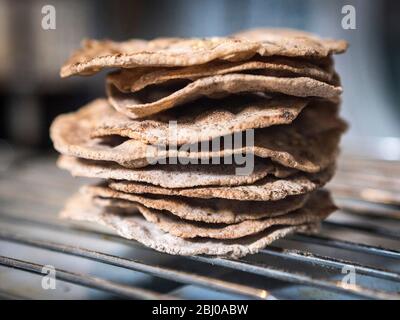 Homemade buckwheat crispbreads, drying on old Rayburn Stock Photo