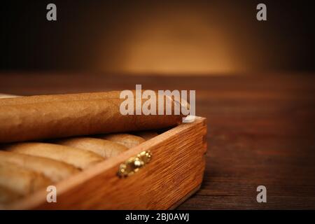 Cigars in humidor on wooden table, closeup Stock Photo