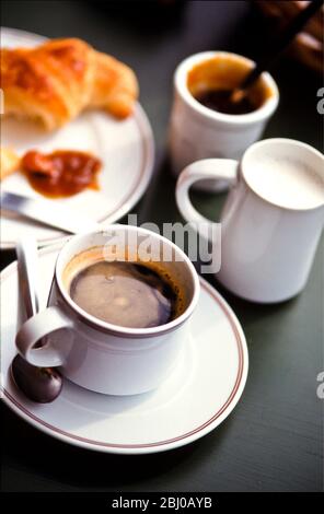 Coffee and croissant on cafe table in south of France - Stock Photo