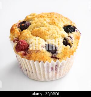 MIxed berry muffin with blueberries and raspberries in paper case - Stock Photo