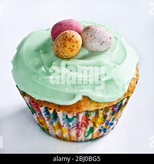 Iced Easter cupcake with chocolate mini eggs - Stock Photo