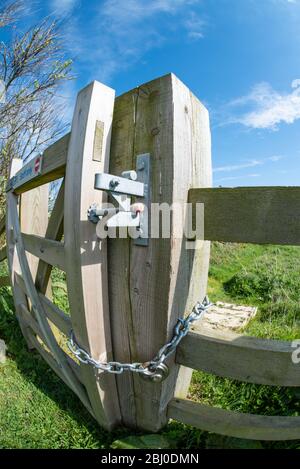 Locked Gate in Wooden Fence UK Stock Photo
