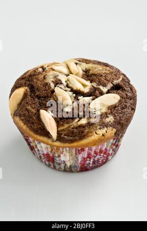 Marbled chocolate and plain muffin with slivers of almonds as topping - Stock Photo