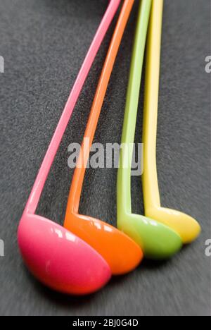 Set of brightly coloured melamine plastic measuring spoons - Stock Photo