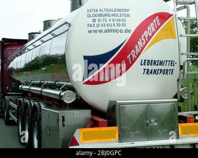 Huge stainless steel road tanker, transporting food stuff in Germany - Stock Photo