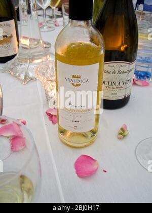 Wines on wedding reception dinner table - Moulin a Vent Clos des PŽrelles and Palazzina, Moscato Passito - Stock Photo