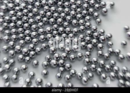Edible silver balls for cake decorating, Shot with Lensbaby lens for blurred edge effect - Stock Photo