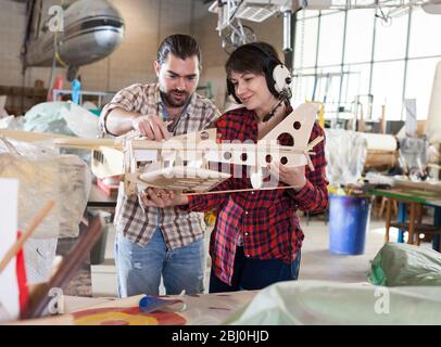 Team of aircraft enthusiasts working in workshop on creating of airplane models Stock Photo