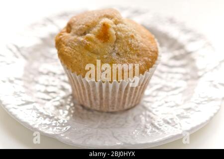 Home made apricot muffin on white plate. - Stock Photo