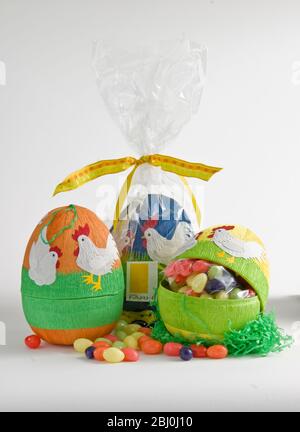 Egg shaped decorated paper box with sugar coated chocolate eggs - Stock Photo