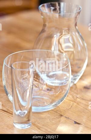 Collection of empty glass vases on wooden table - Stock Photo