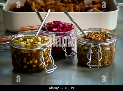 Fresh vegetable chutney, pickled red cabbage and coarse wholegrain mustard accompanying braised beef - Stock Photo