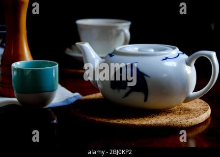 Chineses teapot with variety of tea cups - Stock Photo