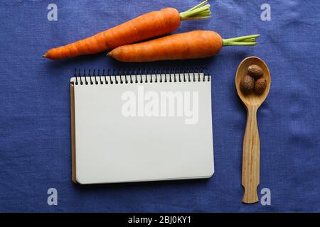 Open recipe book on color napkin  background Stock Photo