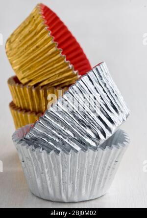 Stack of decorative metallic foil cake and muffin cases - Stock Photo