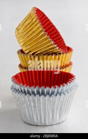Stack of decorative metallic foil cake and muffin cases - Stock Photo