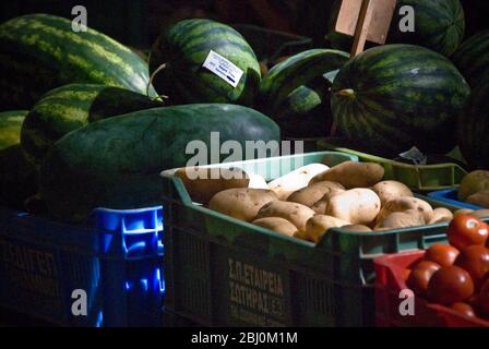 Melons, tomatoes and potatoes for sale in covered market in Limassol, Cyprus - Stock Photo