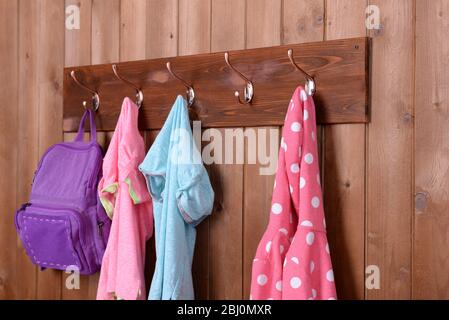 Children things hanging on wall in room Stock Photo