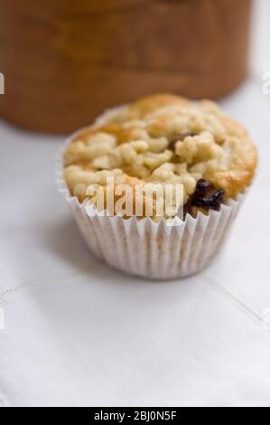 Small currant muffin topped with grated apple - Stock Photo
