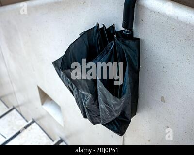 Umbrella hanging on wall Stock Photo