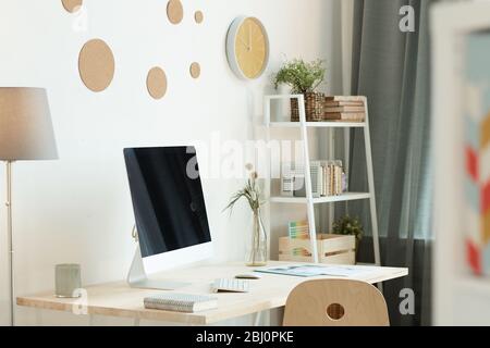 Comfortable workspace in modern room with trendy interior in daylight, horizontal no people shot Stock Photo
