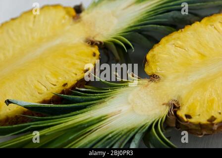 Pineapple cut in half on white background - Stock Photo